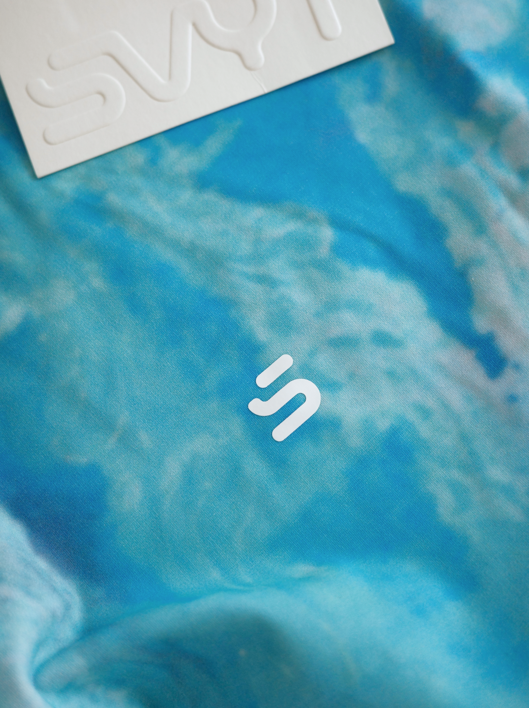 Blue fabric with a white logo on a blue background