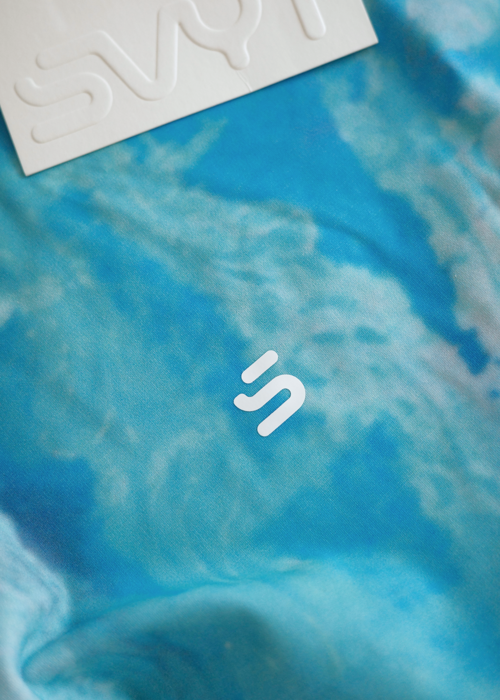 Blue fabric with a white logo on a blue background