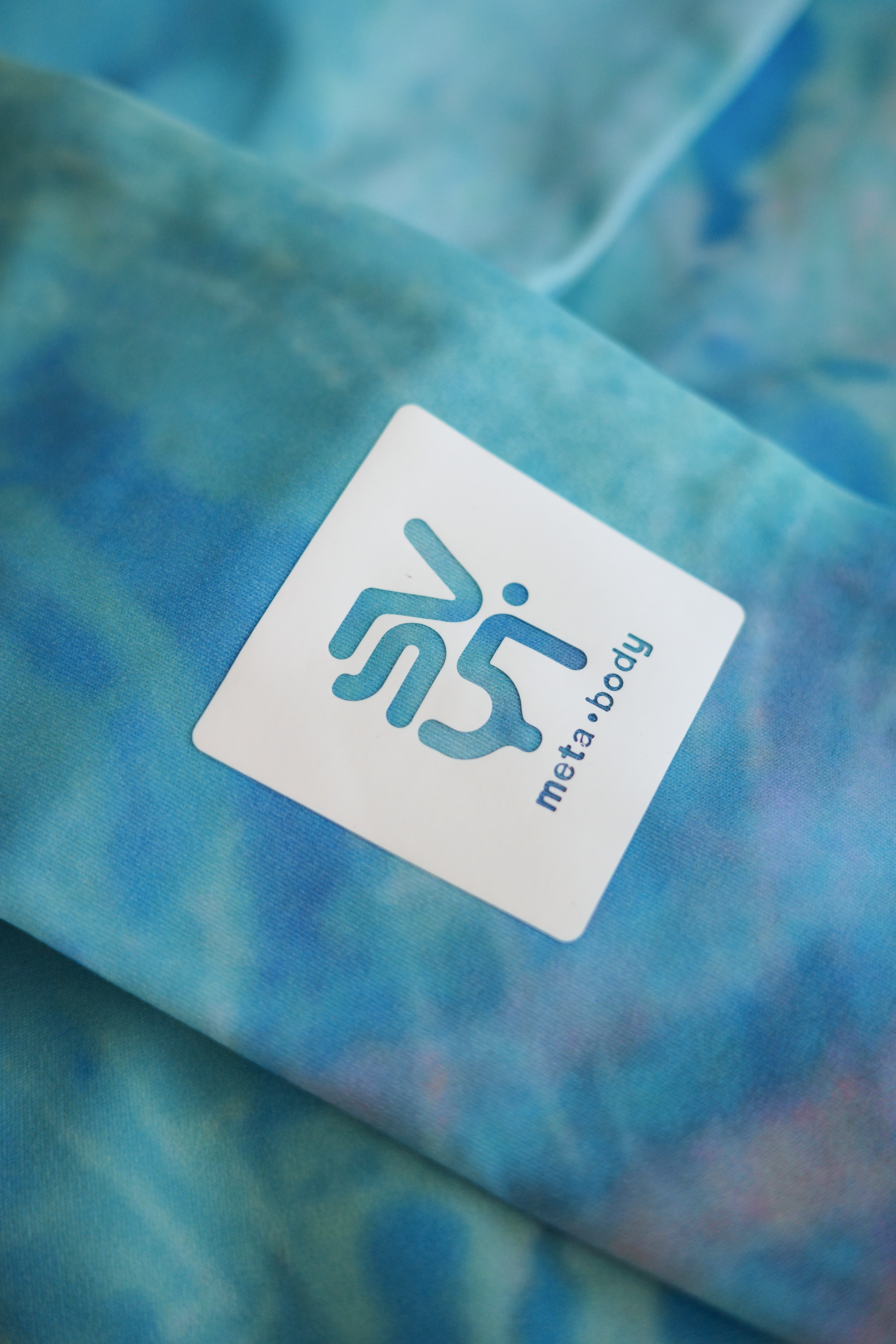Close-up of a blue fabric with a 'svyt meta-body' label.