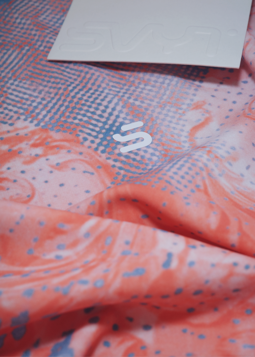 Long sleeve top close up, Textile with a pattern and a visible brand label 
