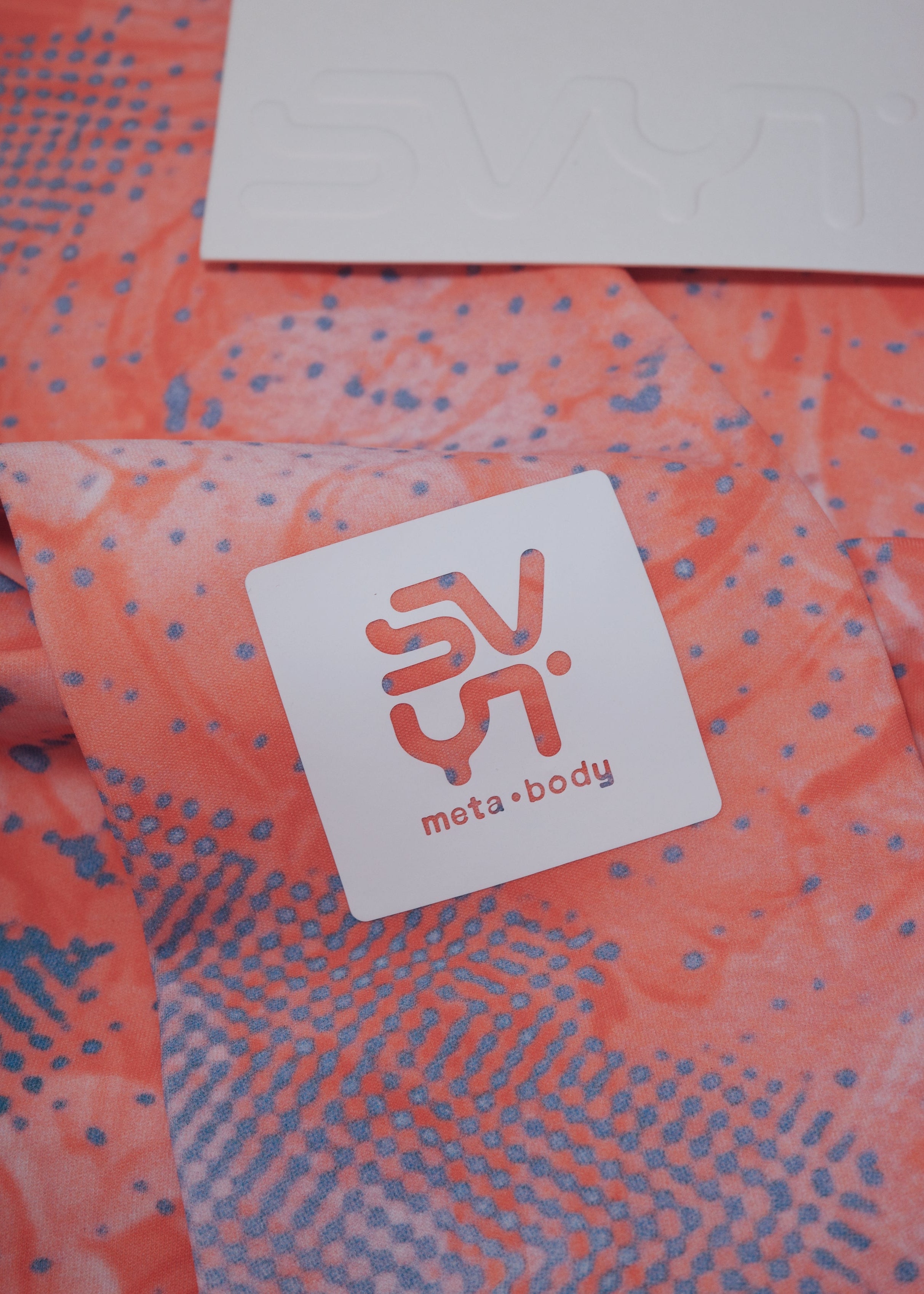 Orange fabric with a white label logo patch SVYT 