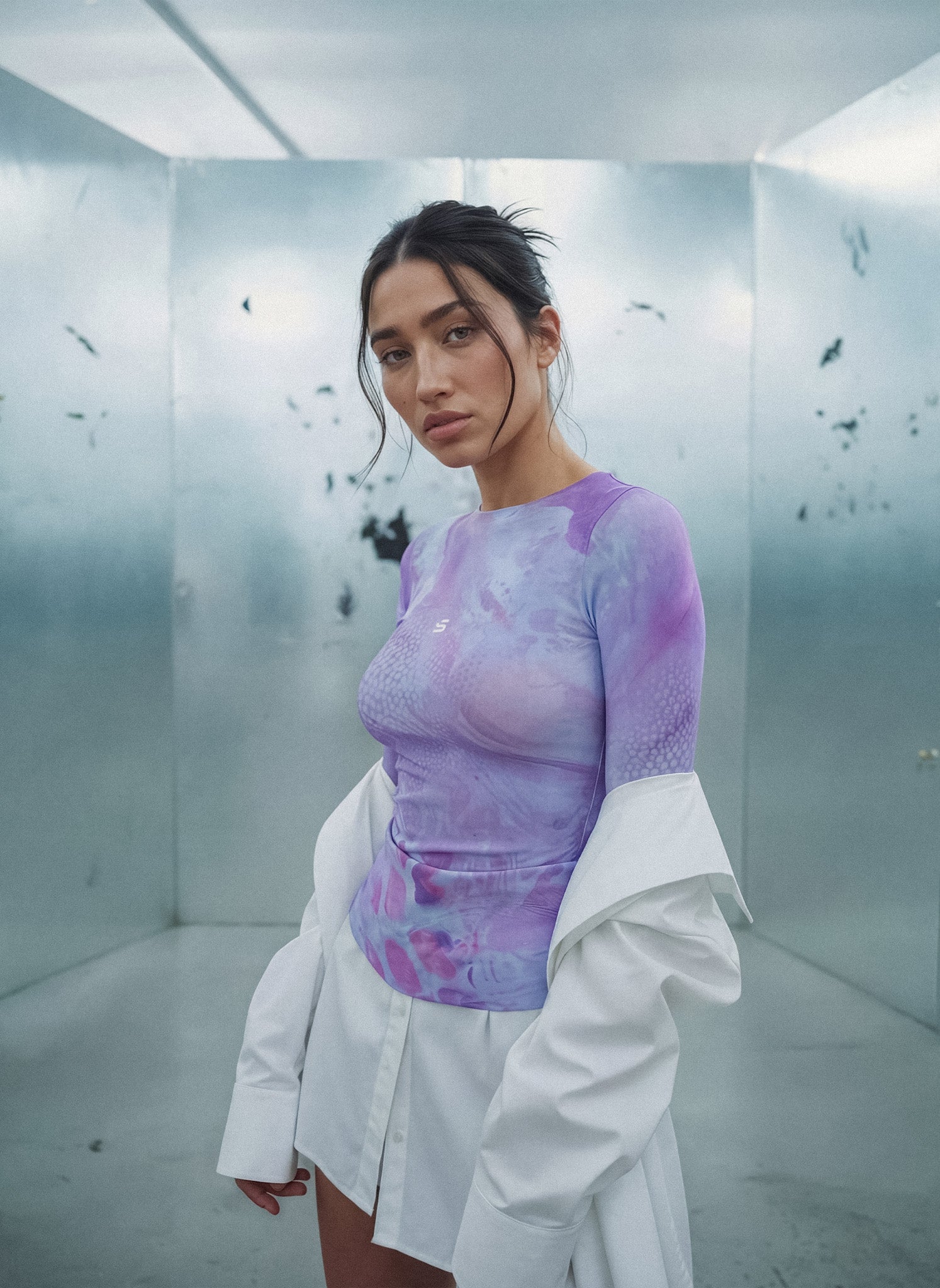 Person wearing a purple and white outfit in a futuristic setting