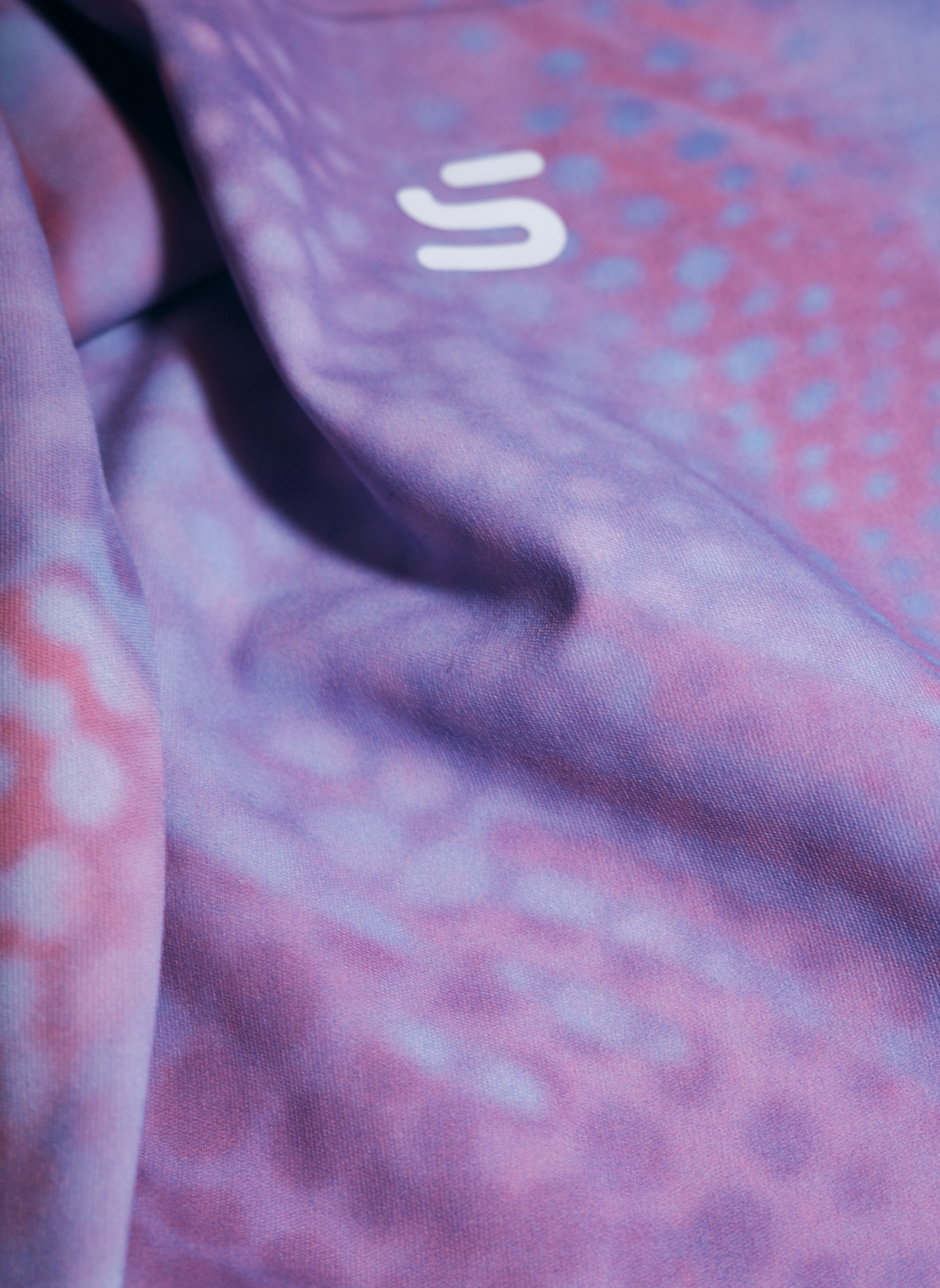 Close-up of SVYT MIST long sleeve top fabric with logo detail
