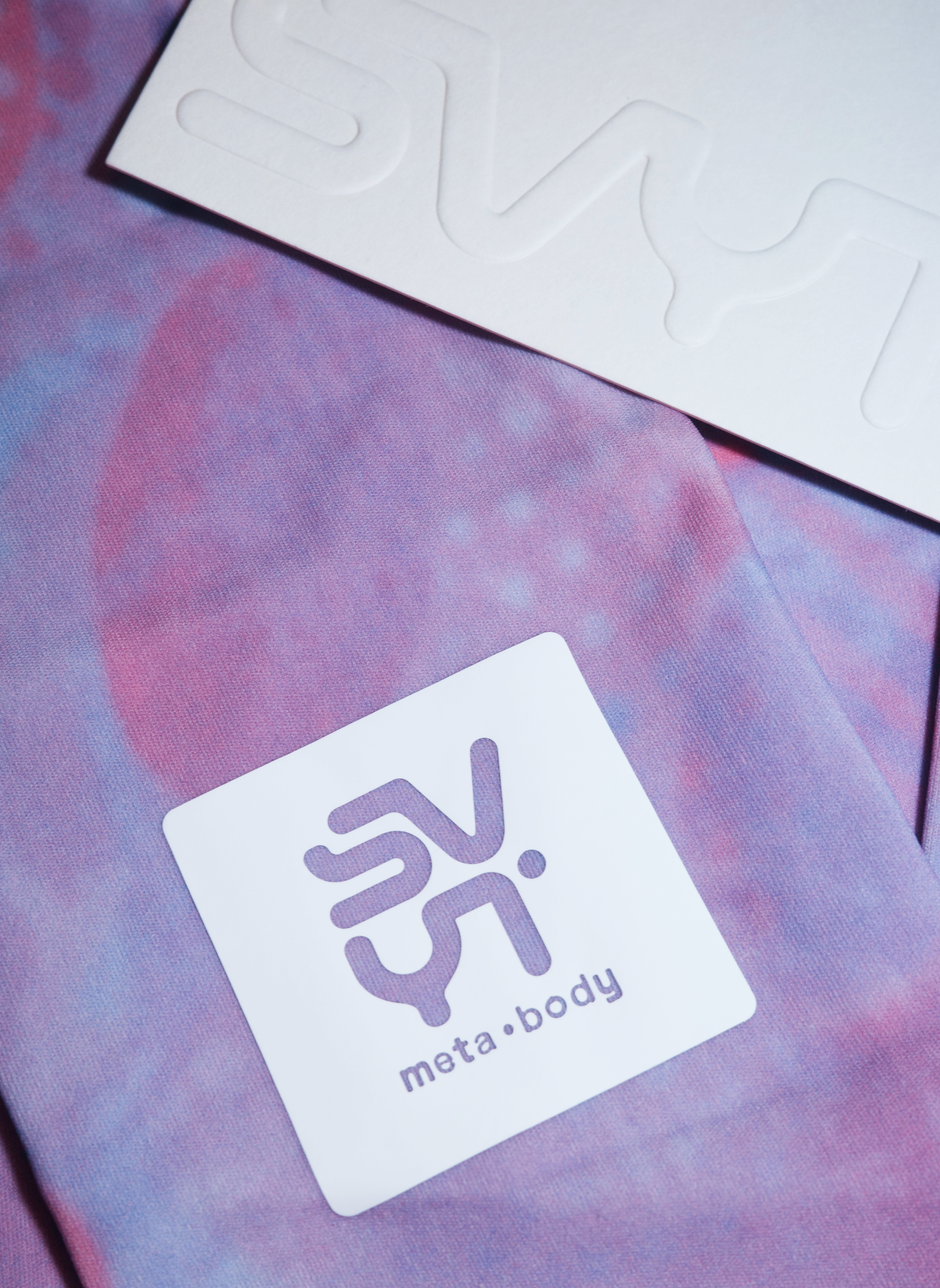 Close-up of SVYT MIST long sleeve top fabric with logo detail