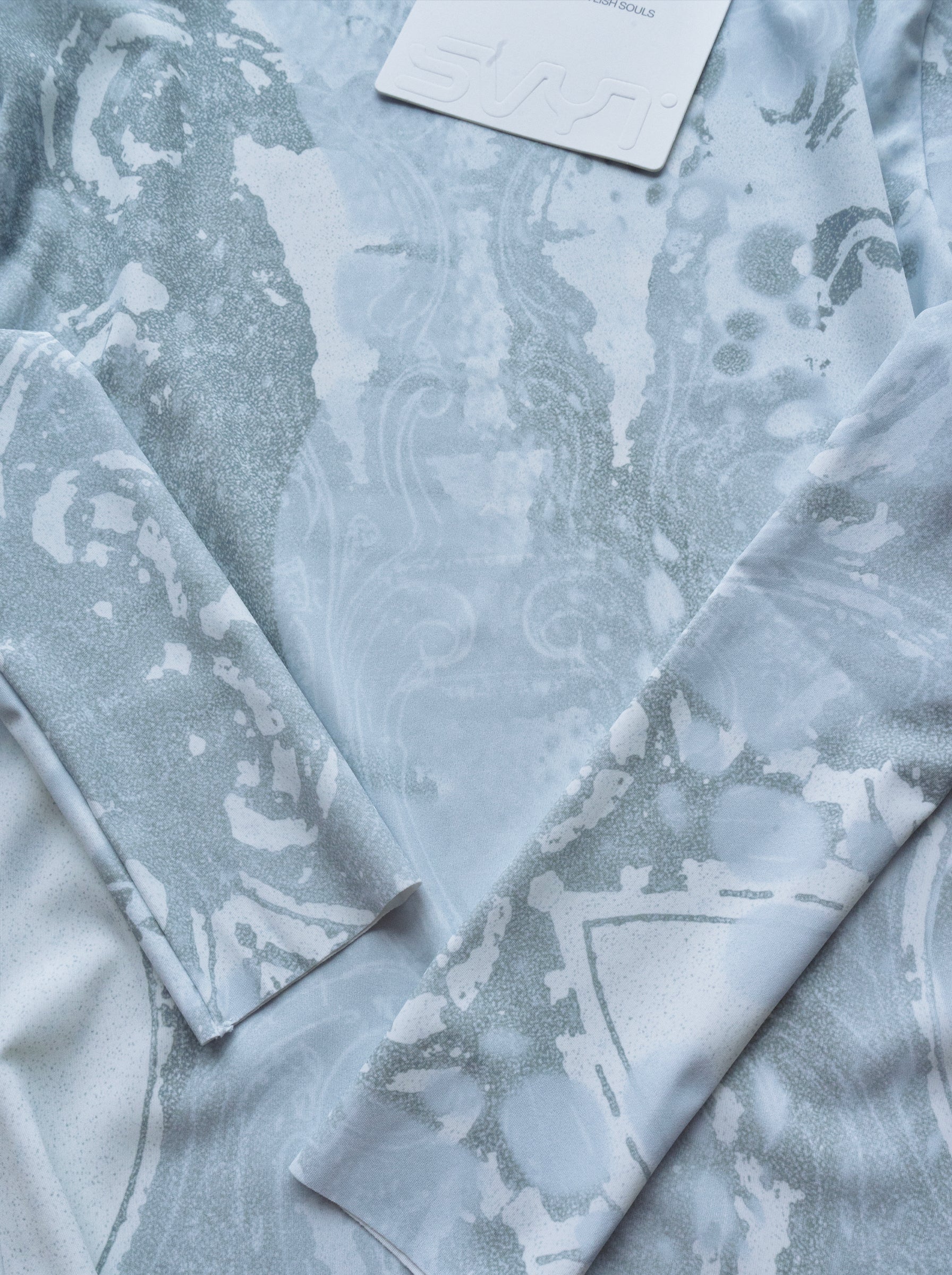 Light blue fabric with a subtle pattern on a white background