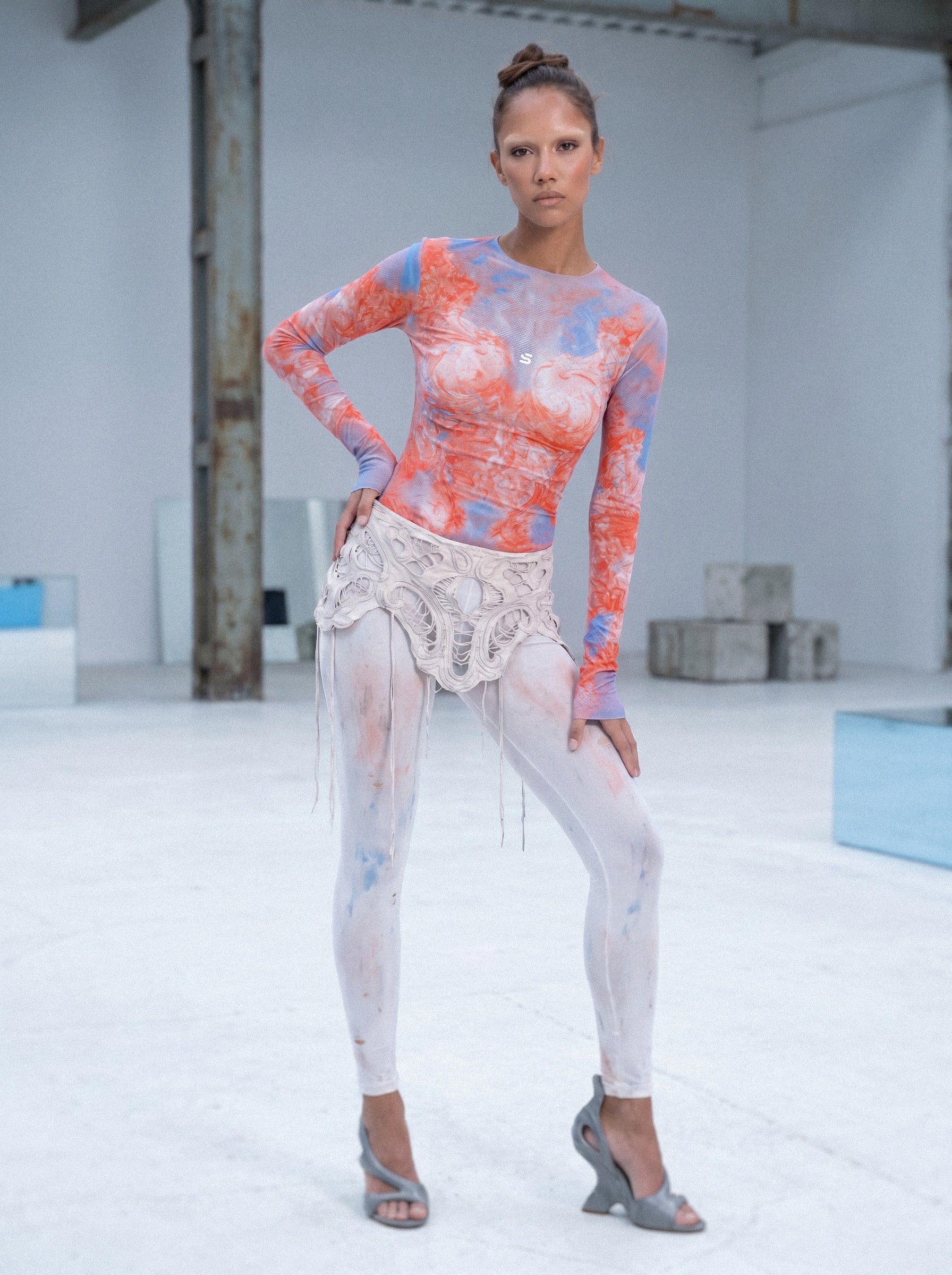 Model wearing a colorful outfit with a white background